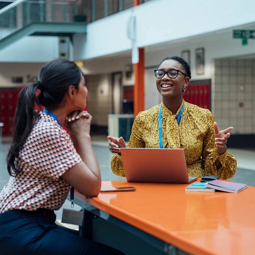 two coworkers laughing at work