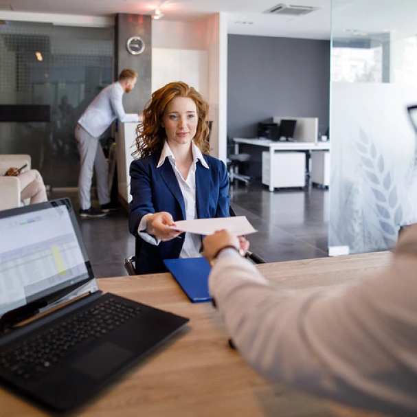 woman handing her cv to boss