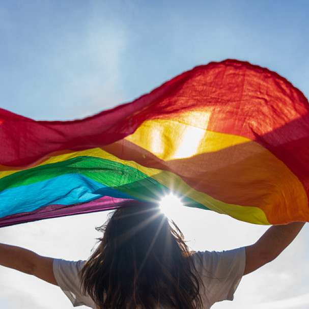 woman waving pride flag