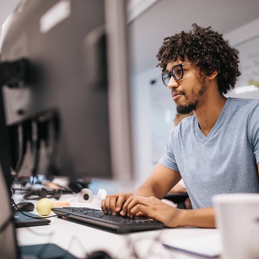 man sitting at desk working first job