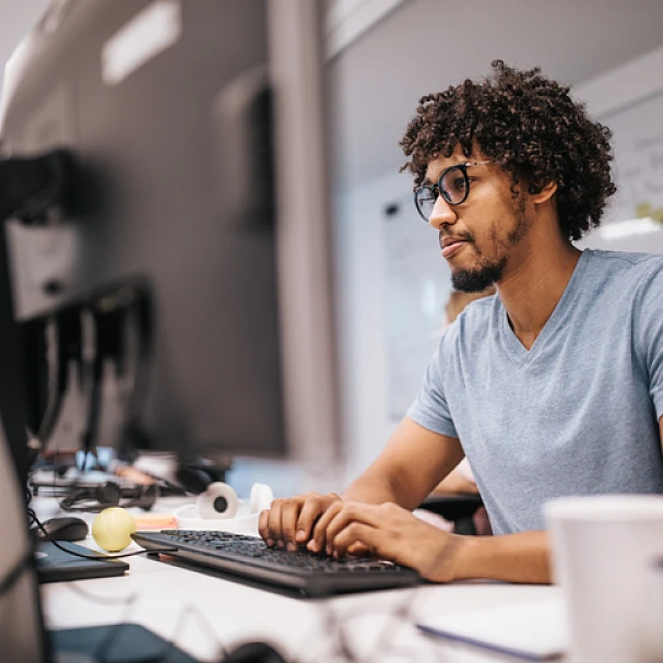 man sitting at desk working first job