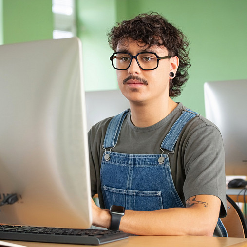 young man working in tech office