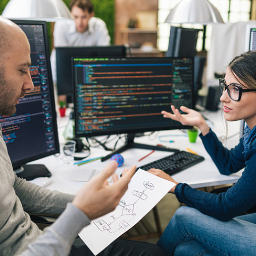 two coworkers discussing hiring strategies