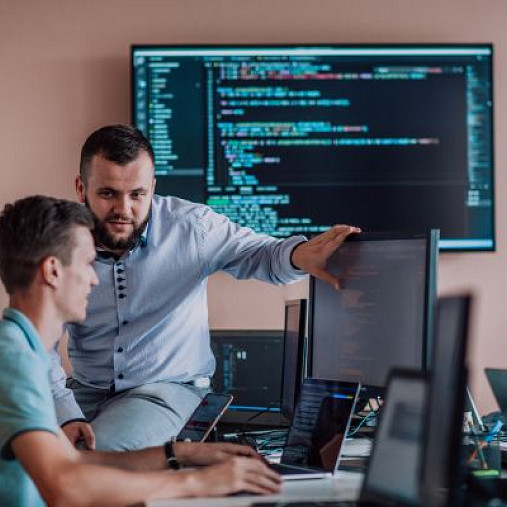 man training colleague in cybersecurity